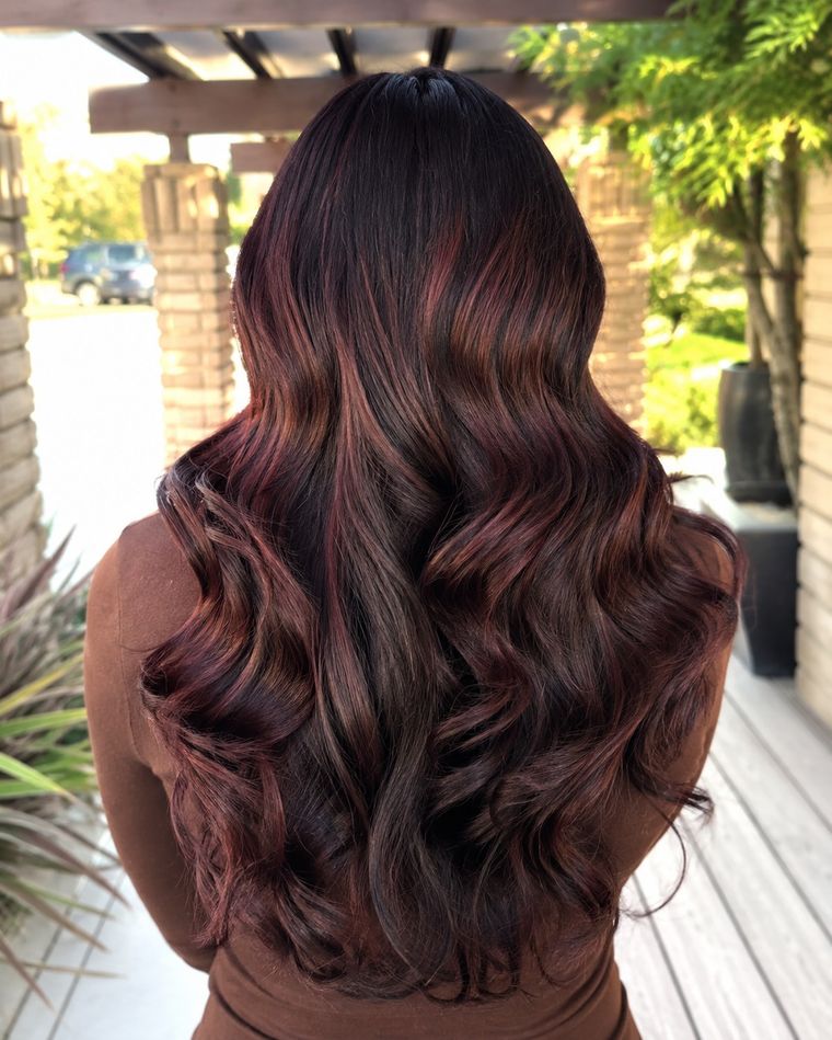 Dark brunette with red ribbons of colour through soft waves